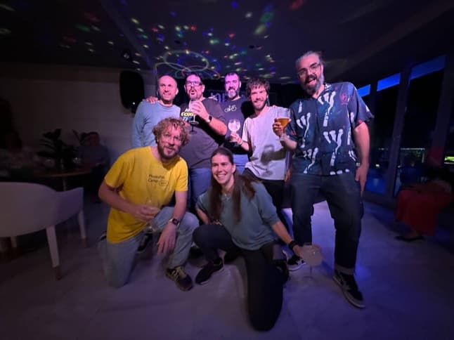 The team together at a party under a starry ceiling