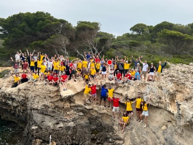 The PhotoPills Camp 2022 group photo on a rocky coast