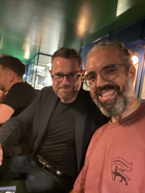 Two colleagues smiling on an evening out