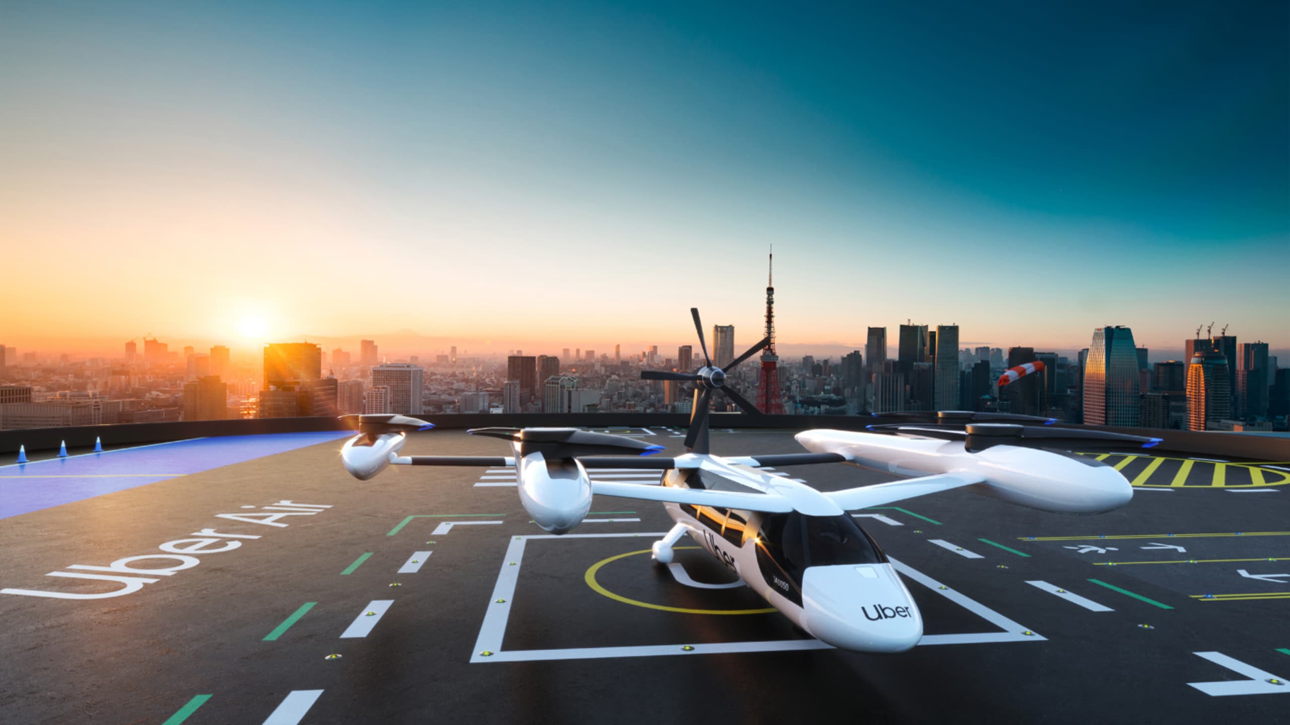 Uber Air concept: an air taxi on a rooftop skyport at sunset