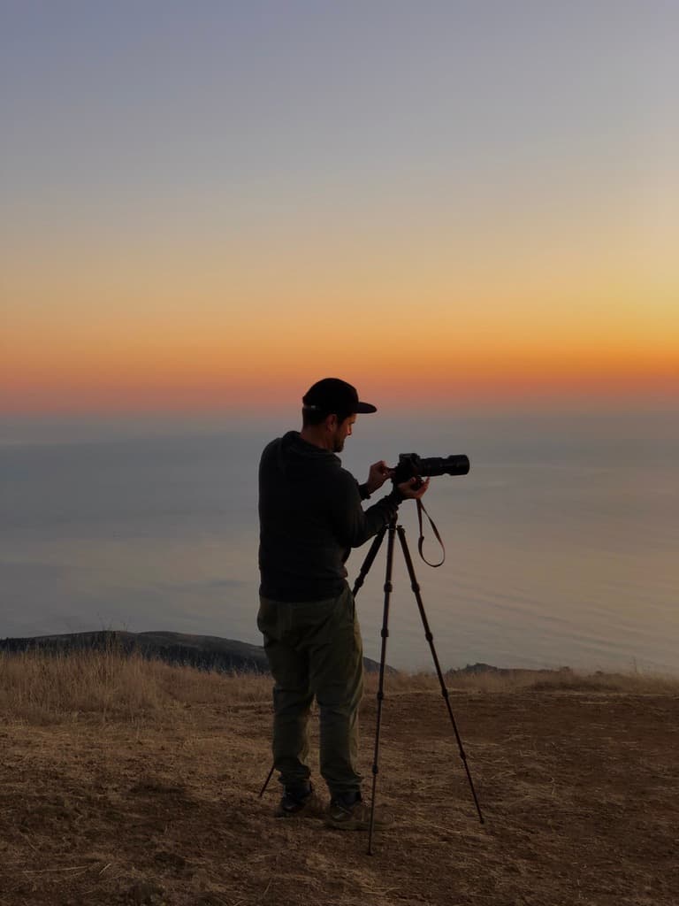 Photographing the sunset over the Pacific from a hilltop